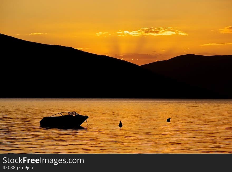 Sunset in Mediterranean bay with boat in foreground. Sunset in Mediterranean bay with boat in foreground