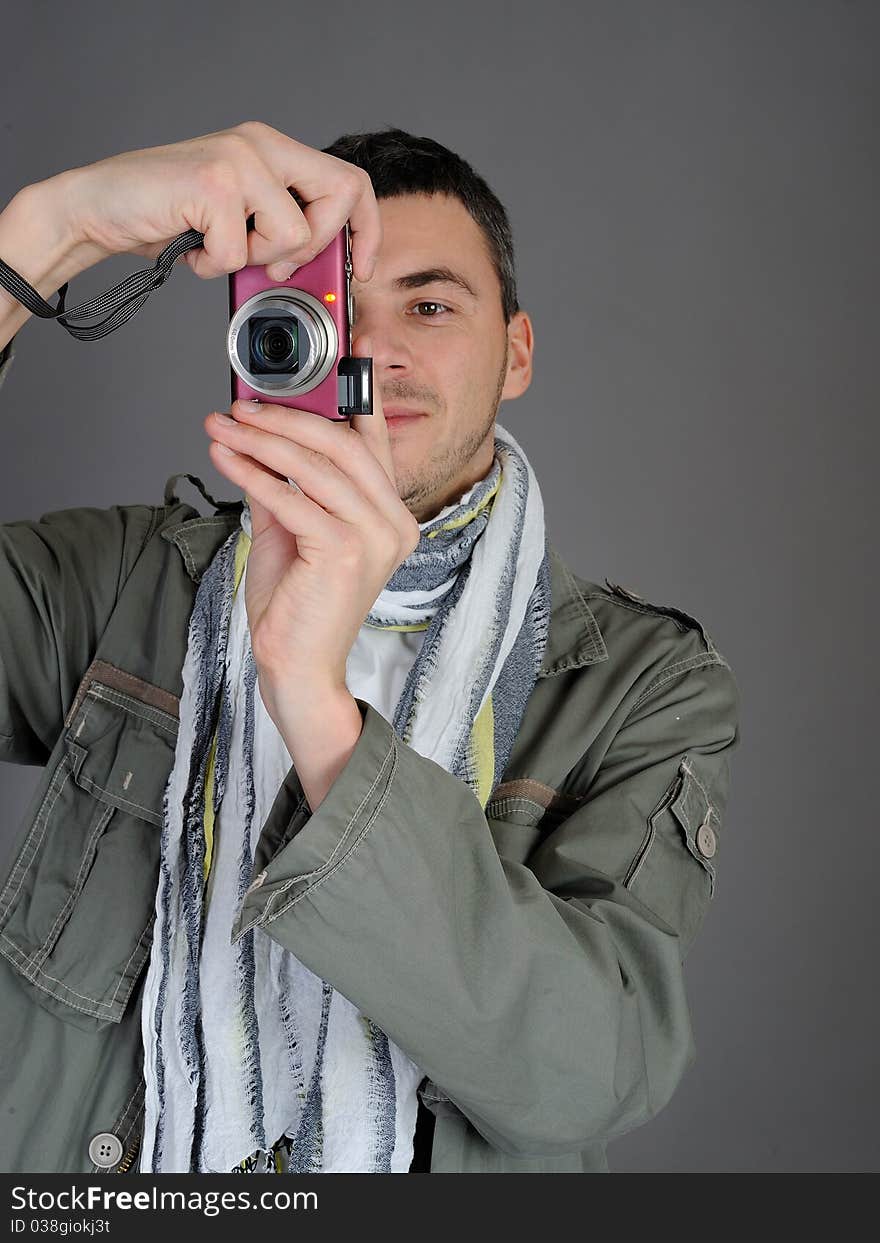 Young man with digital photo camera. isolated on white background. Young man with digital photo camera. isolated on white background