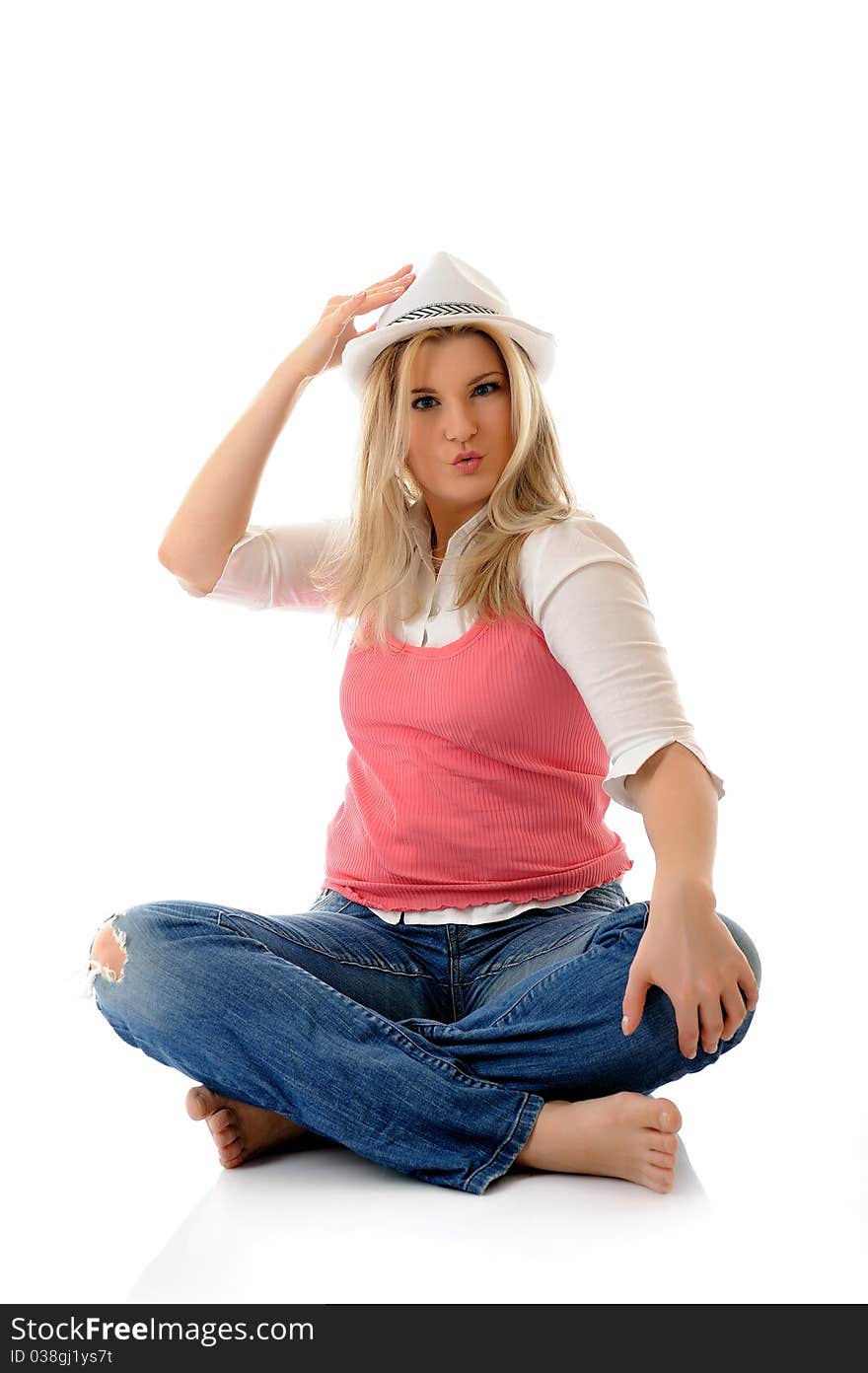 Young casual smiling woman in white hat