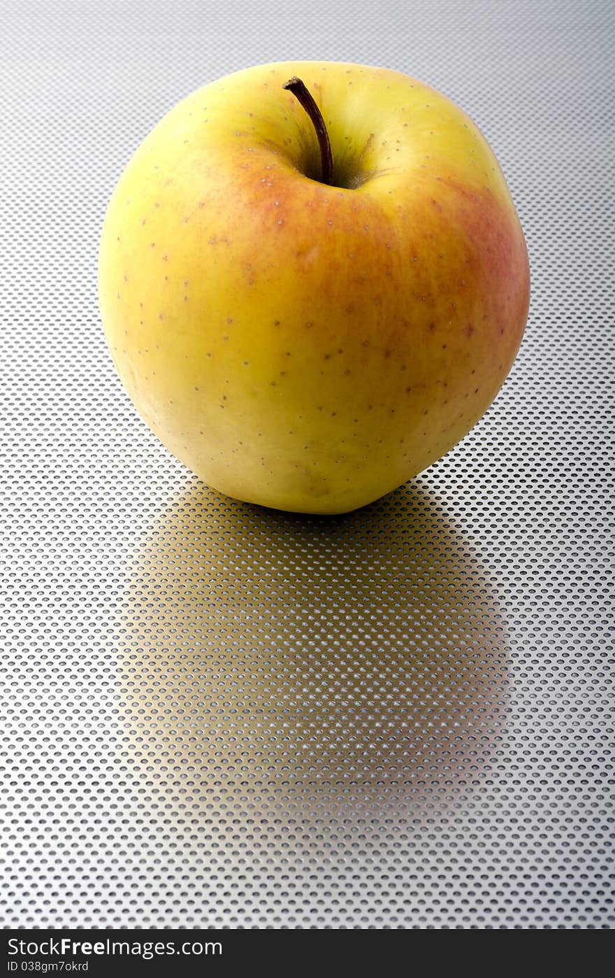 Apple on a perforated aluminum bottom