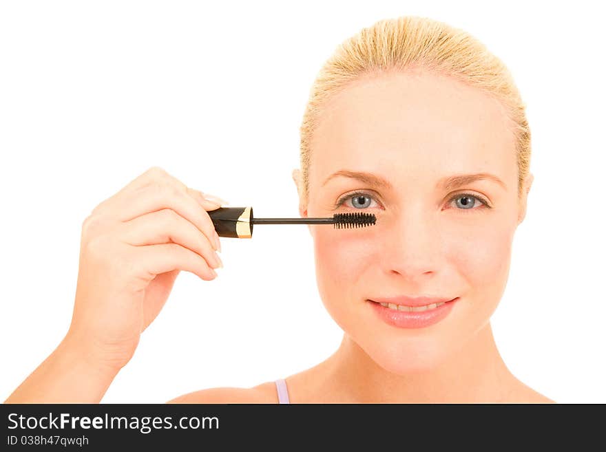 Woman applying mascara in the white background