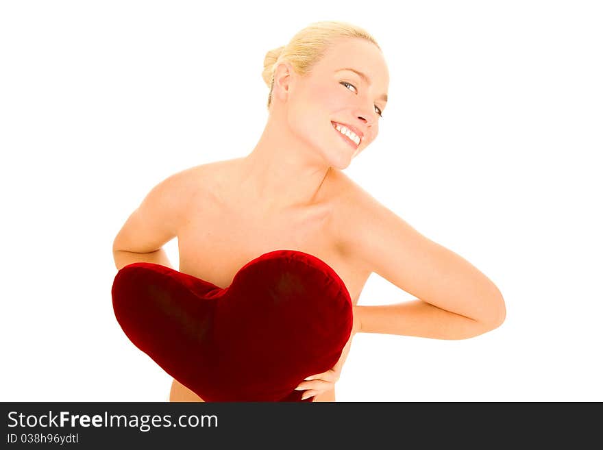 Naked woman with heart-shaped pillow in the white background