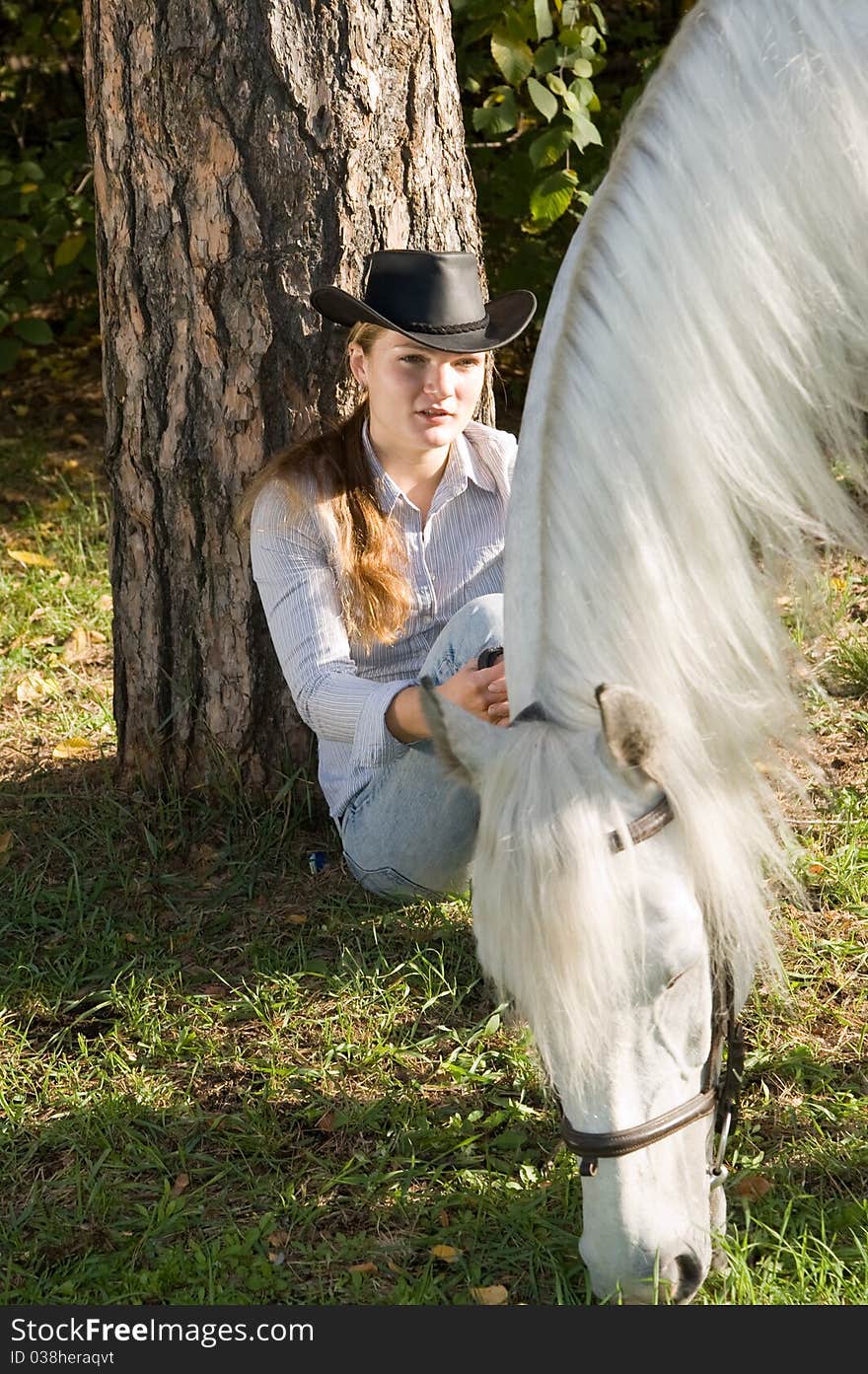 Portrait of young woman with her white horse on a green grass. Portrait of young woman with her white horse on a green grass