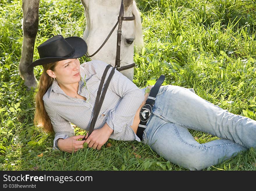 Portrait of young woman with her white horse on a green grass. Portrait of young woman with her white horse on a green grass