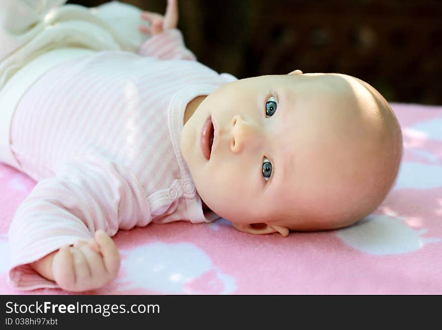 A portrait of little child is in pink tones