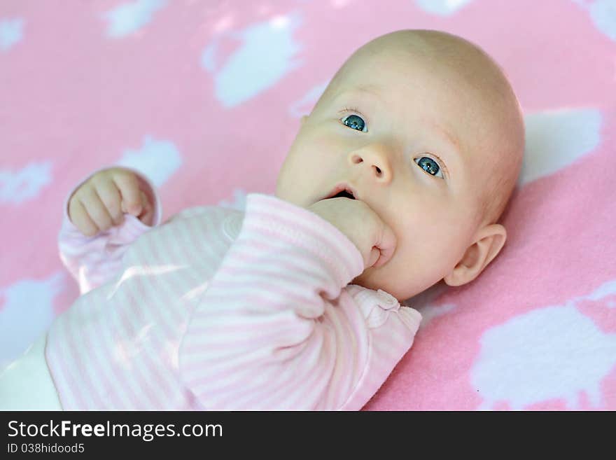 A portrait of little child is in pink tones