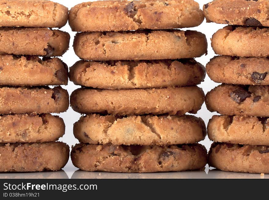 Pile of chocolate chip cookies, every cookie comes with a lot of chocolate chips, fresh baked just out of the oven isolated on white with copyspace