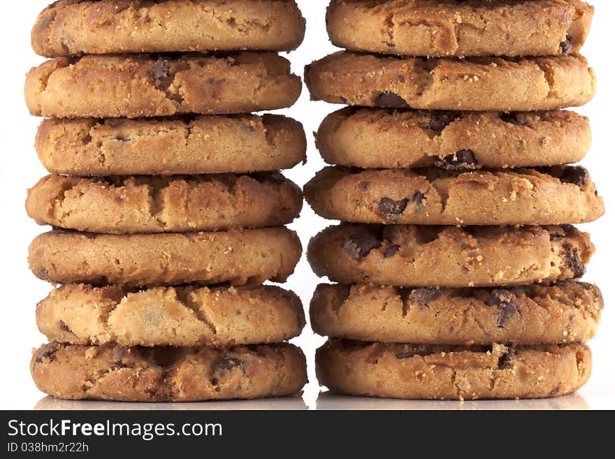 Pile of chocolate chip cookies, every cookie comes with a lot of chocolate chips, fresh baked just out of the oven isolated on white with copyspace