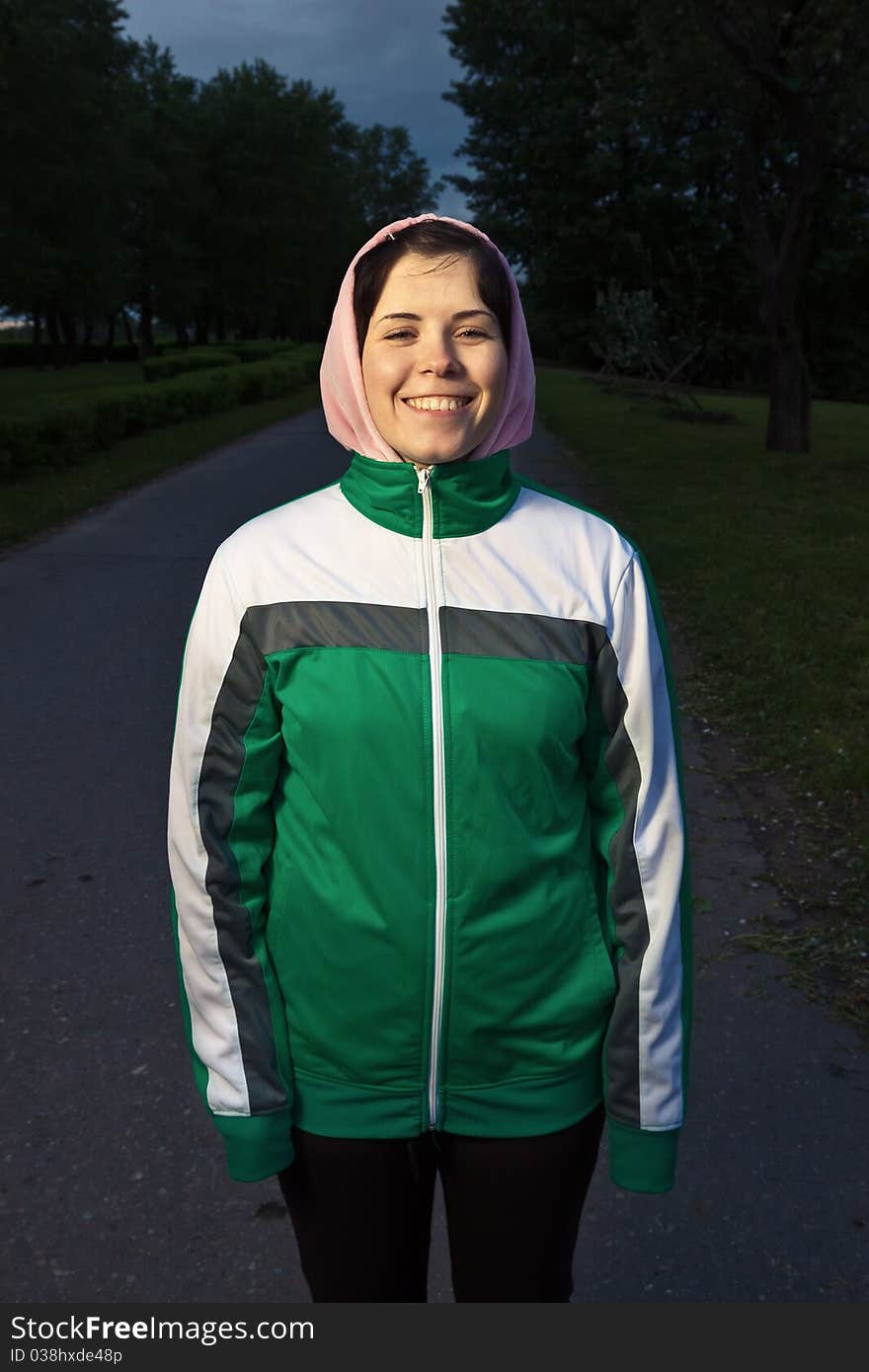 Young smiling woman in sport clothes looking into the camera