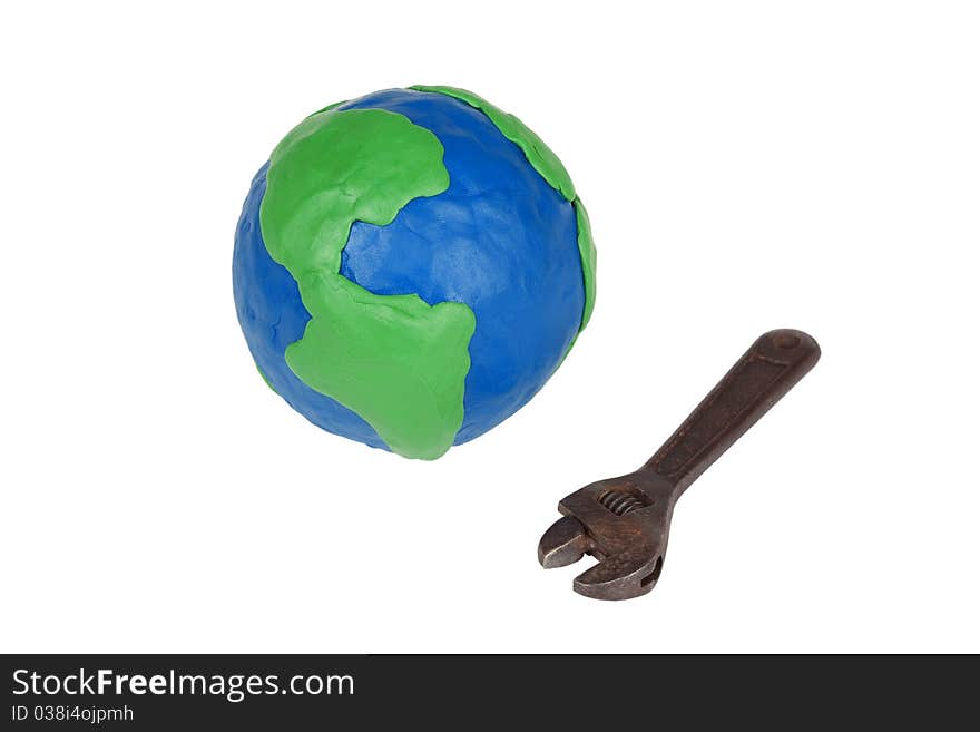 Model of the globe and an old wrench on a white background. Model of the globe and an old wrench on a white background