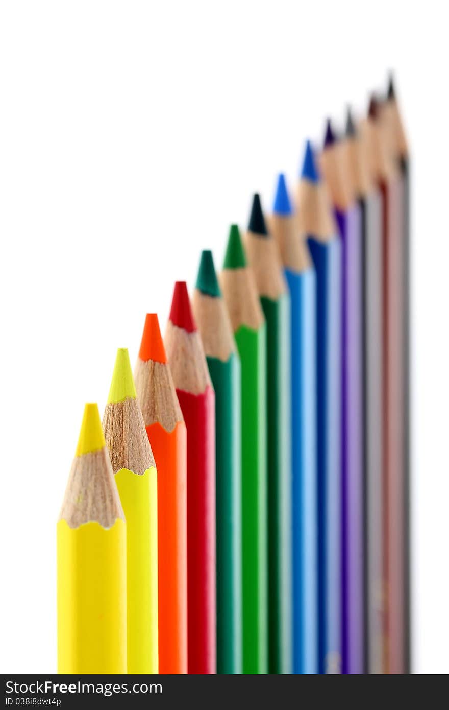 Colored pencils isolated on white background. Shallow depth of field