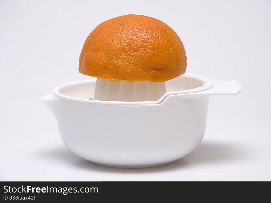 Juice maker with orange on grey background