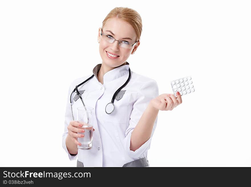 Young woman with stethoscope and pills on a white background. Young woman with stethoscope and pills on a white background