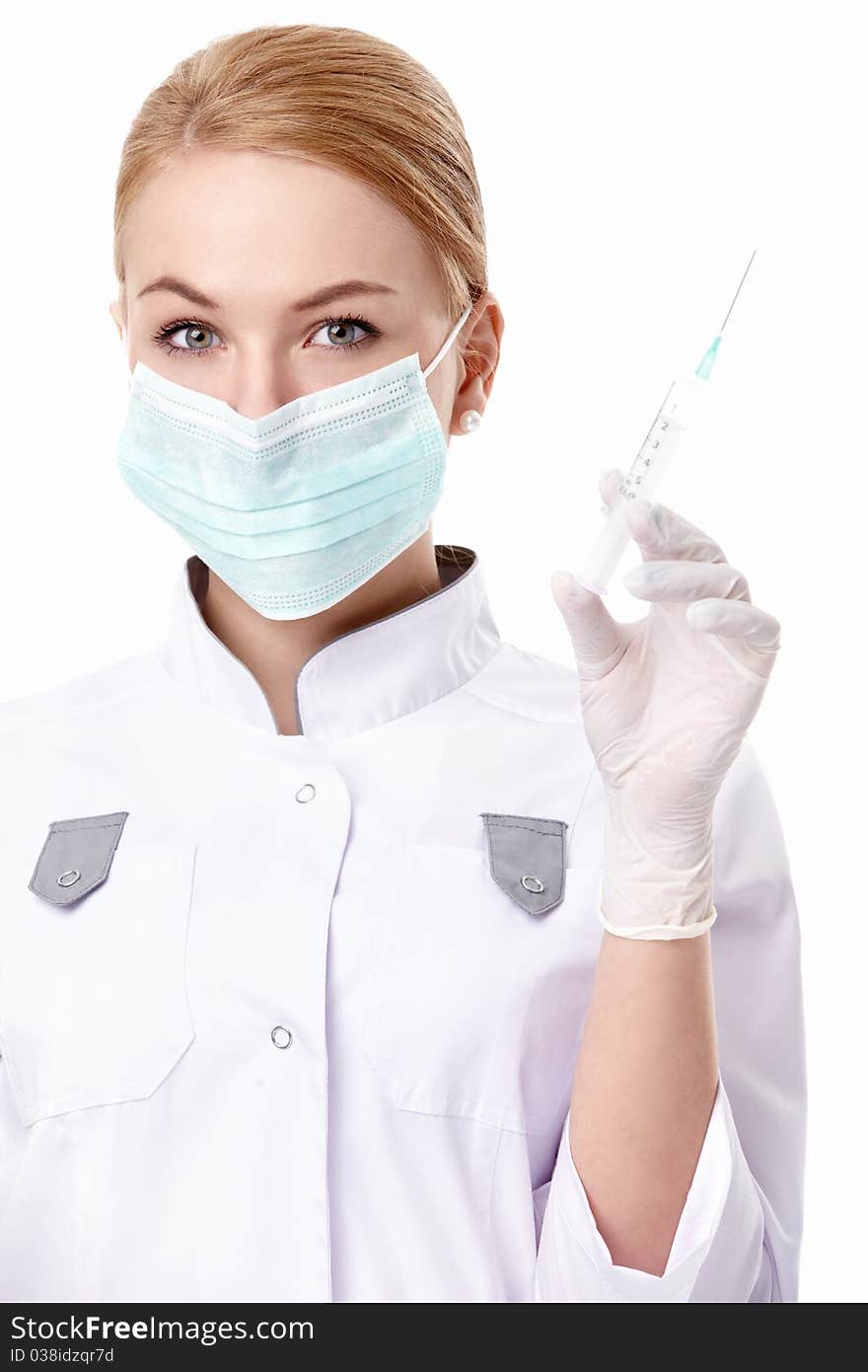 A young doctor with a syringe on white background. A young doctor with a syringe on white background