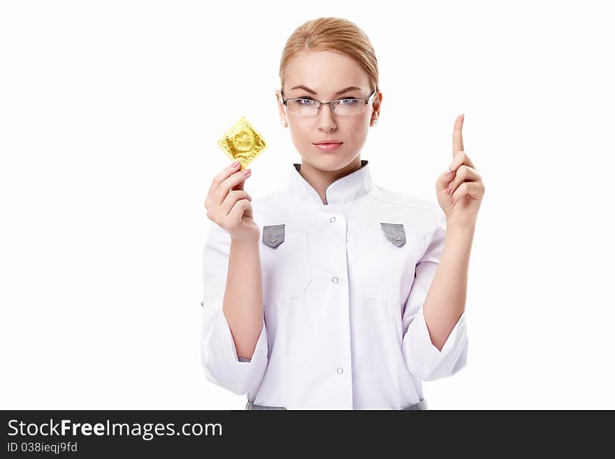 A young doctor with a condom on a white background. A young doctor with a condom on a white background