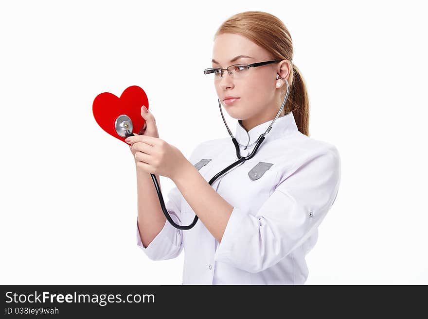 Young doctor listens to the heart on a white background. Young doctor listens to the heart on a white background