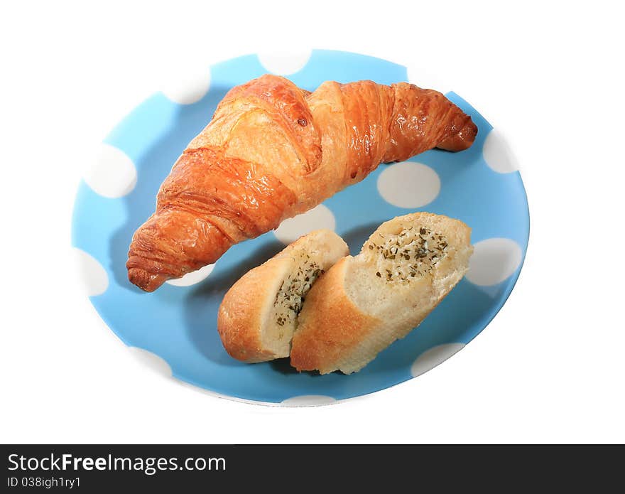 Croissant and garlic bread in a plate on white background. Croissant and garlic bread in a plate on white background.