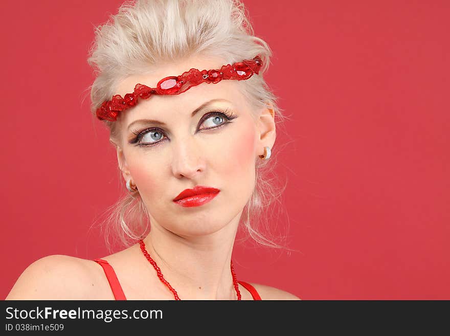 Beautiful female face on red background - close-up