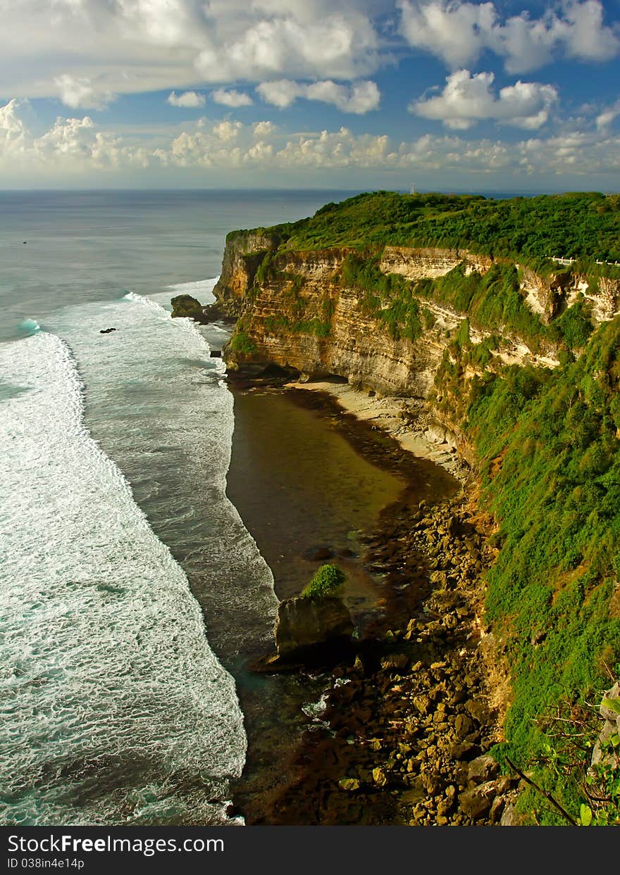 Bali green cliffs under cloudy sky near ocean