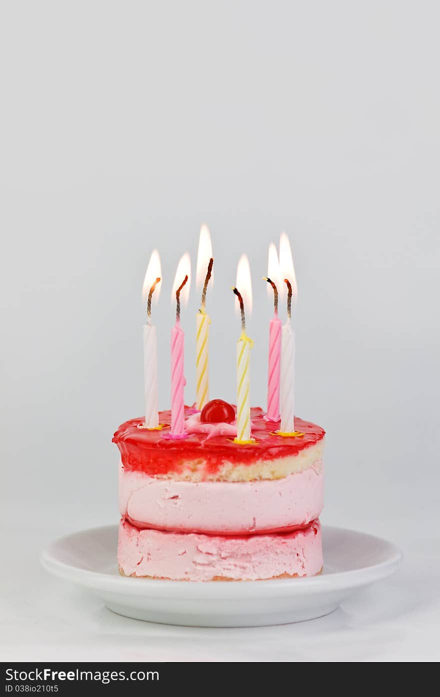 Cake with candle on wood table