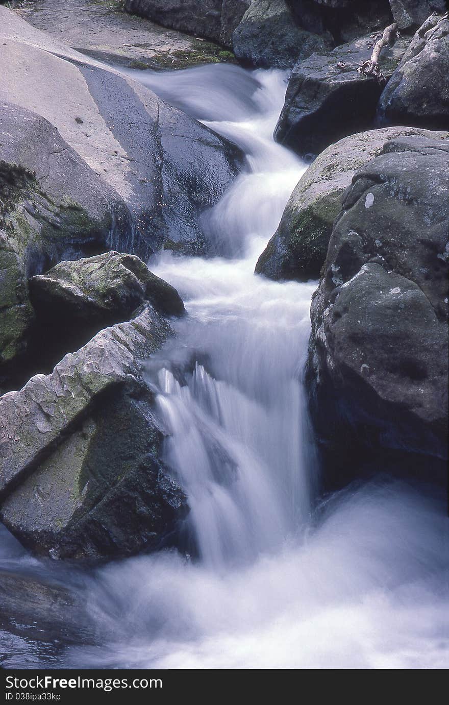 A small waterfalls in a mountain stream. A small waterfalls in a mountain stream.