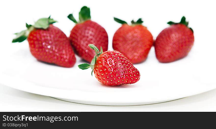 Isolated fruits - Strawberries on white plate.