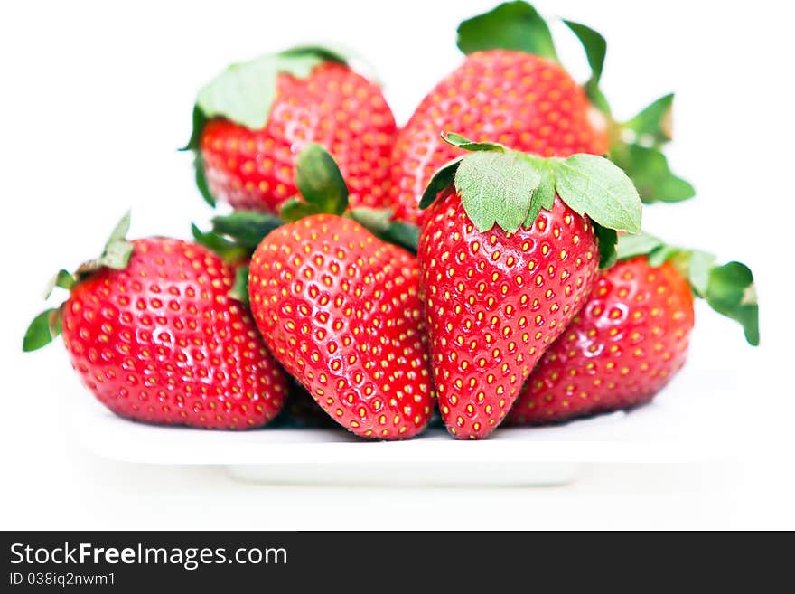 Isolated fruits - Strawberries on white plate.