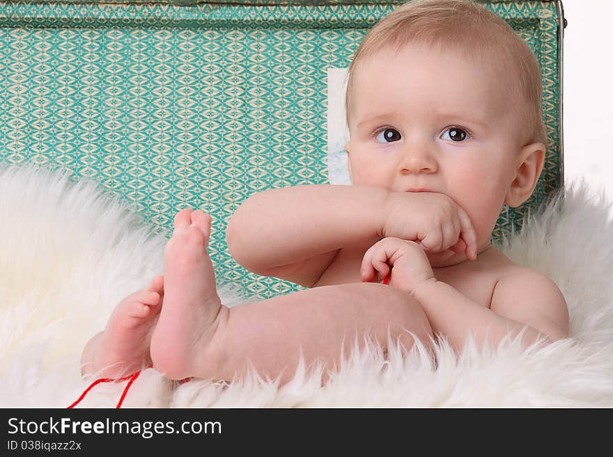 Cheerful little baby boy on green background