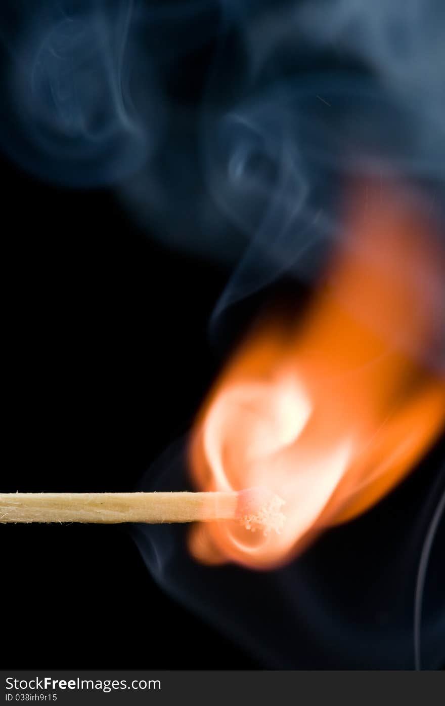 Wood match with fire and smoke