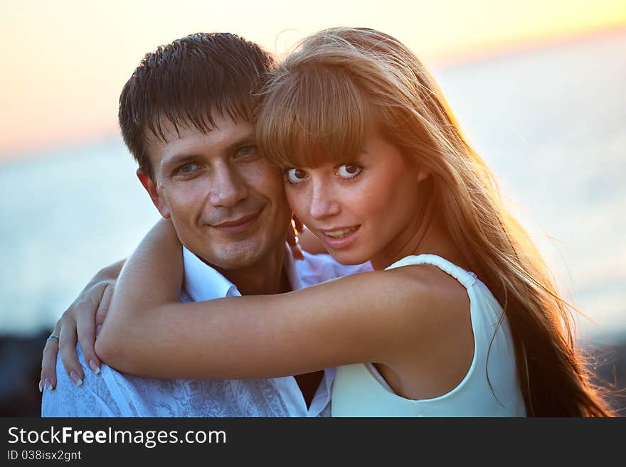 Portrait of a happy young couple having fun on the beach. Portrait of a happy young couple having fun on the beach.