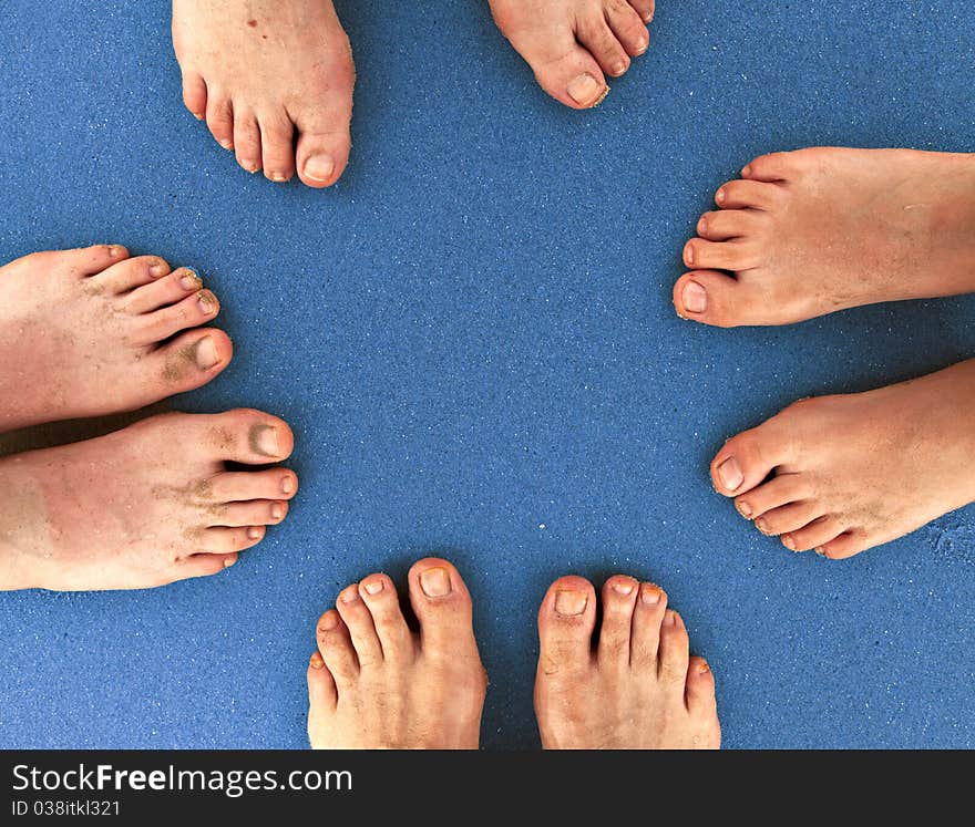 Feet of family standing together at beach. Feet of family standing together at beach