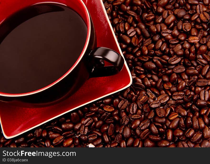 Coffee in cup and saucer with beans on the side. Coffee in cup and saucer with beans on the side