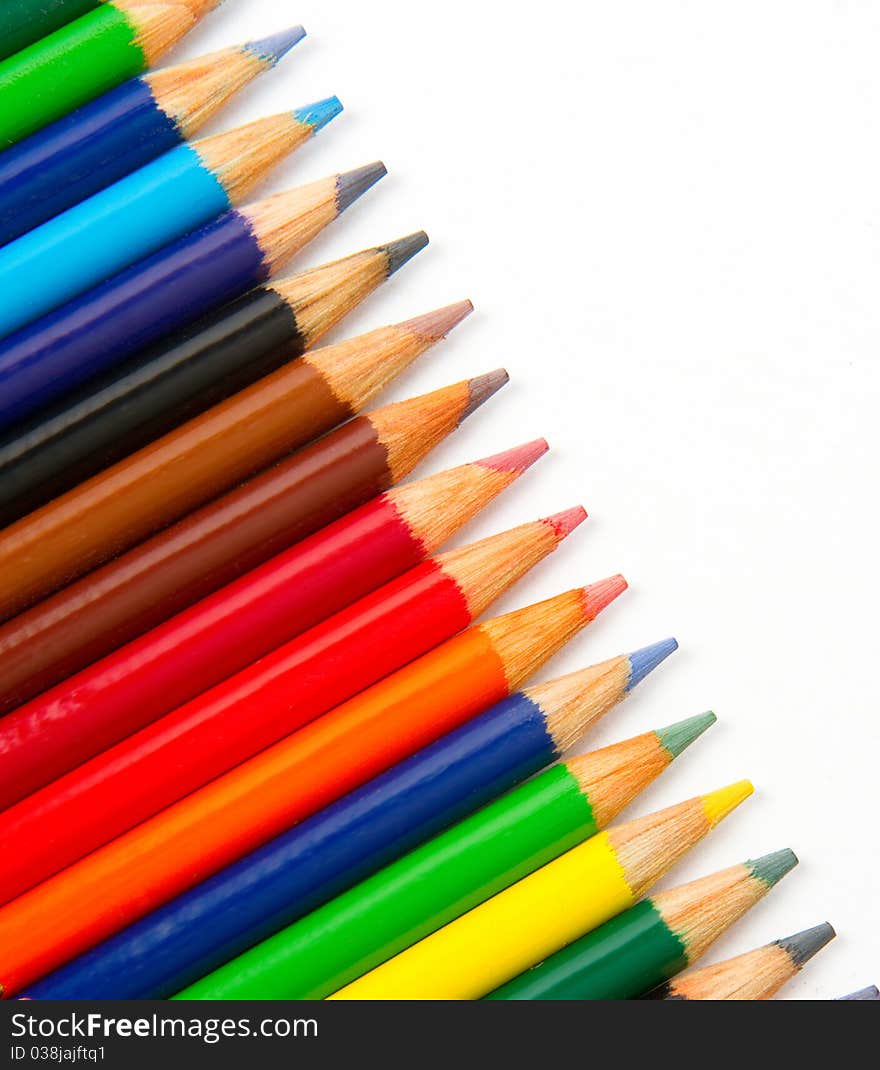 Colored Pencils in a row on white. Colored Pencils in a row on white