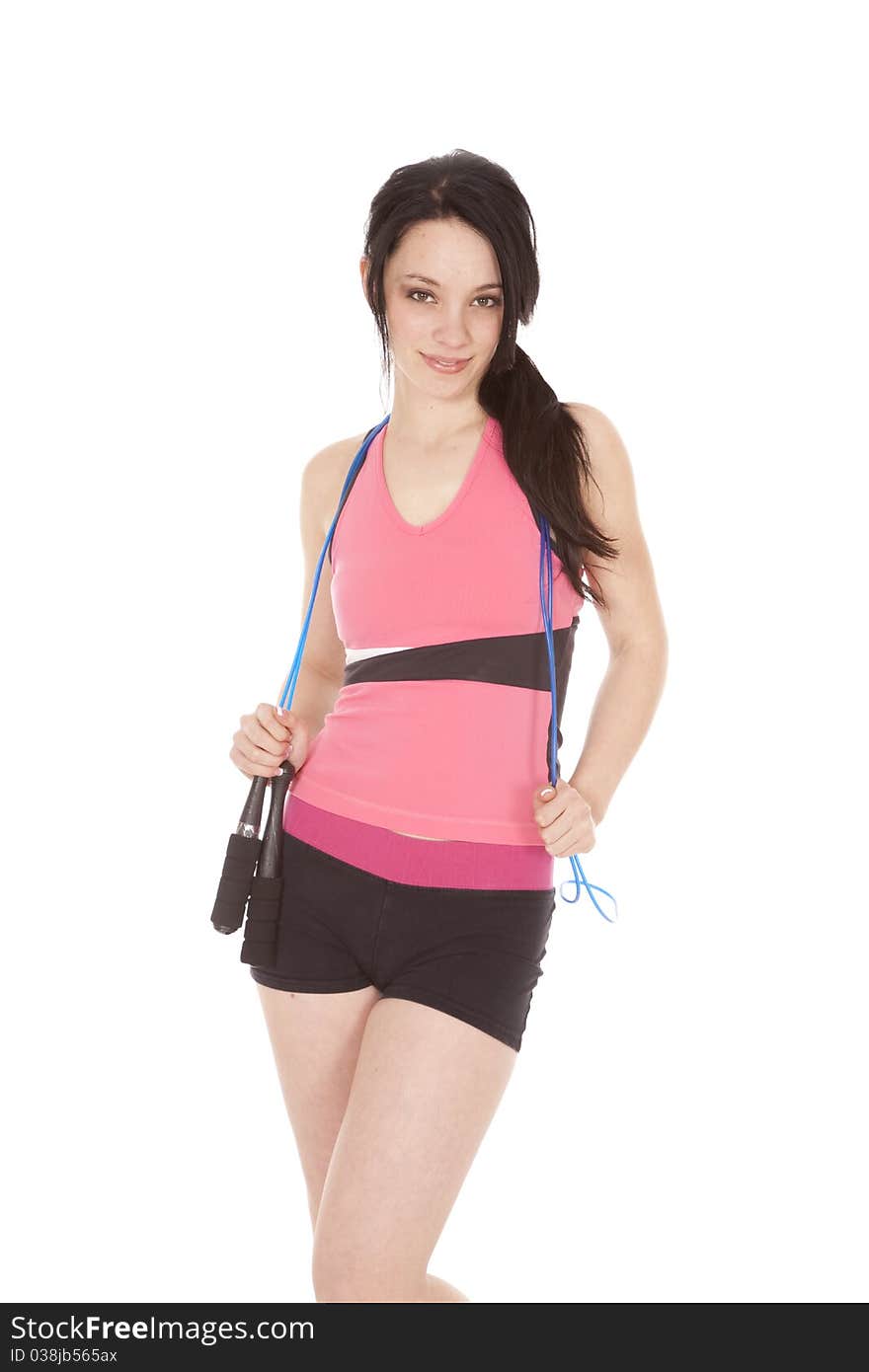 A woman is holding a jump rope around her neck. A woman is holding a jump rope around her neck.