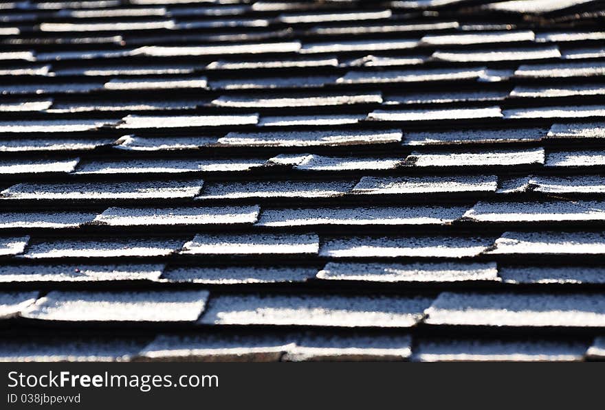 Frost on composite roof shingles creates a repeating pattern. Frost on composite roof shingles creates a repeating pattern.