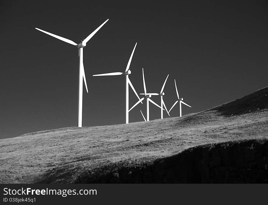 Wind generators strand on the hill creating electricity. Wind generators strand on the hill creating electricity