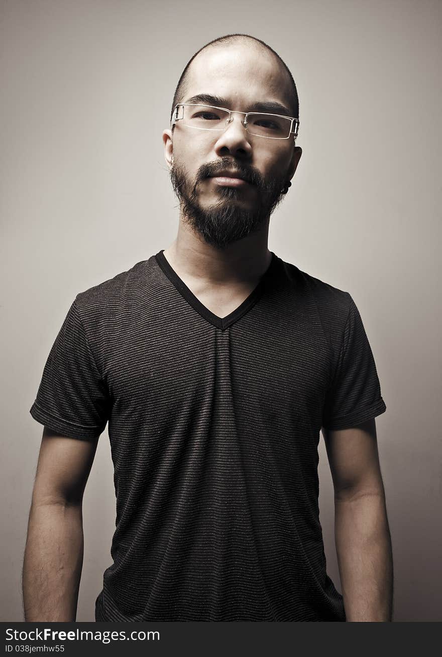 Asian man with glasses against a plane back ground