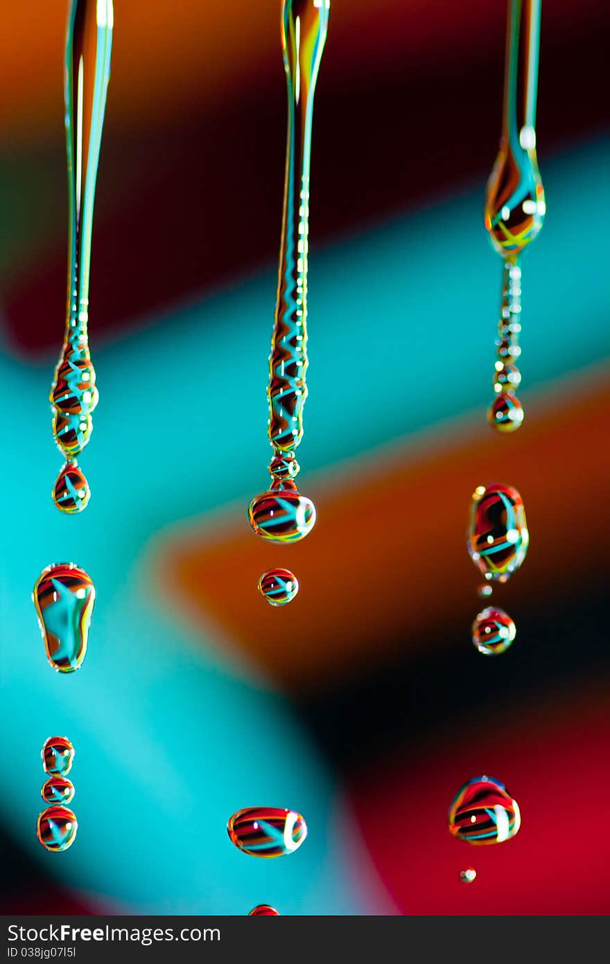 Droplets of water falling into a pool of water. Droplets of water falling into a pool of water.