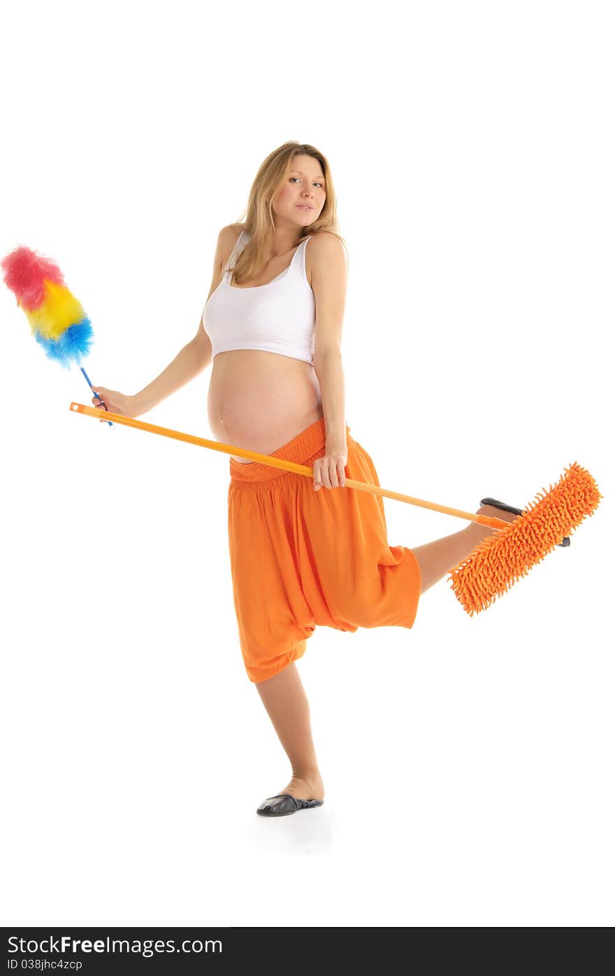 Happy pregnant woman with a mop and brush