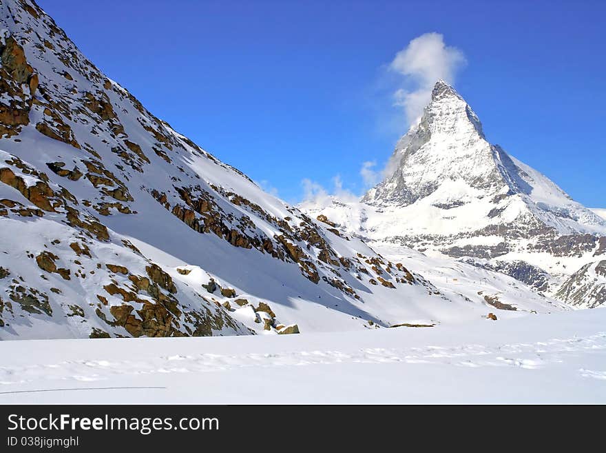 Matterhorn Peak in Swiss Alps with red rock landscape