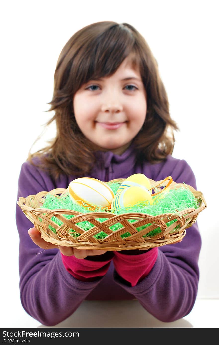 Little girl with easter eggs in a punnet