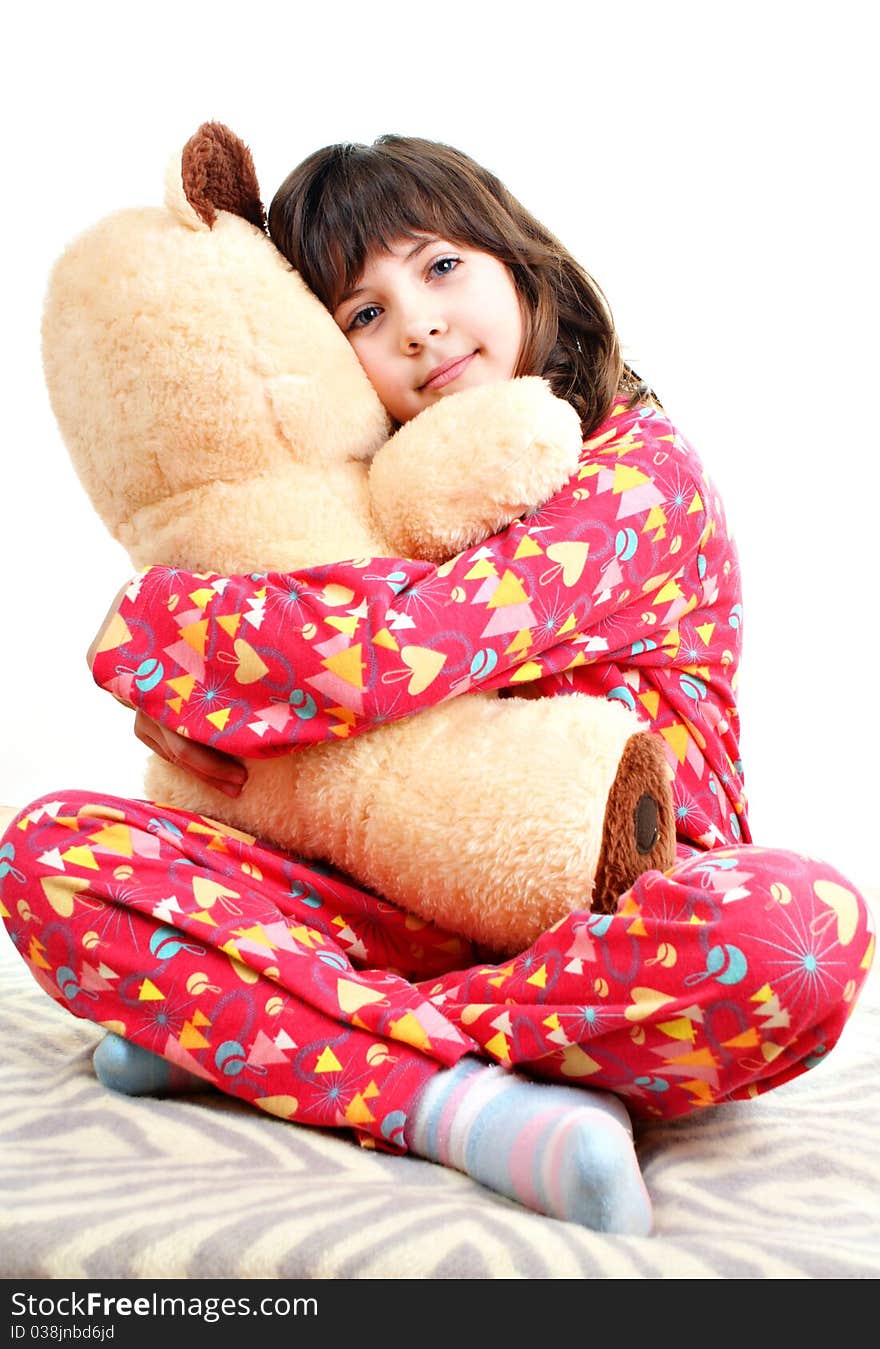 Little girl with toy bear isolated on a white background