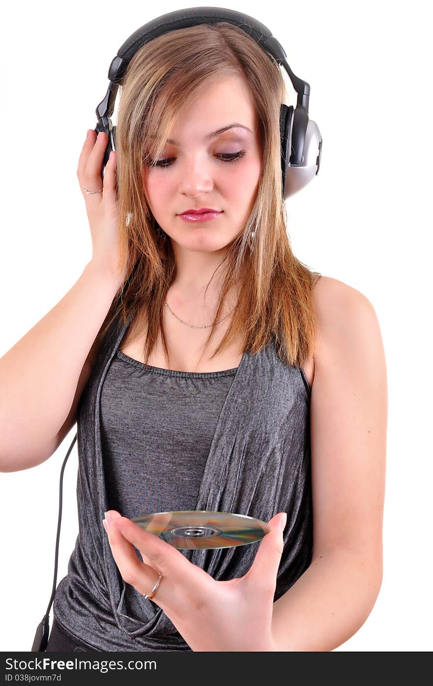 Girl with headphones looking at the cd isolated over white background