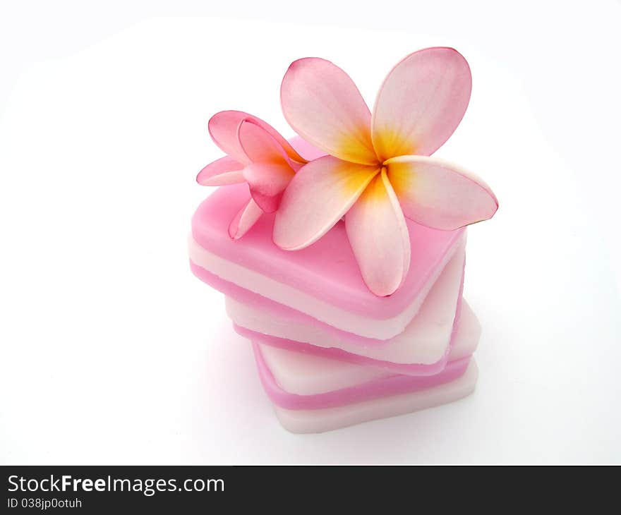 Frangipani on pink candle