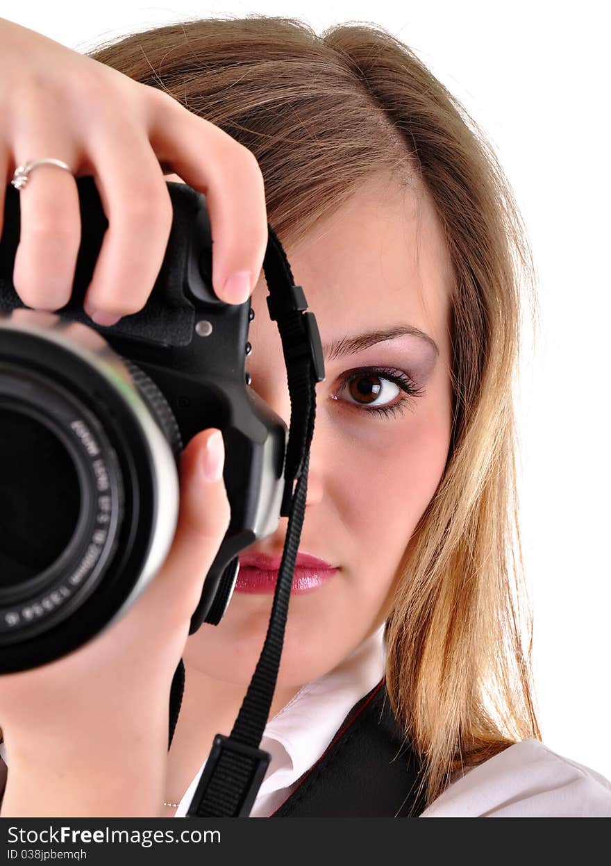 Young woman with photographic camera on white background