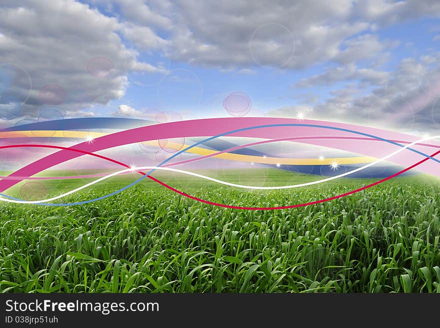 A beautiful green field under a blue sky with multicolored glowing lines. A beautiful green field under a blue sky with multicolored glowing lines