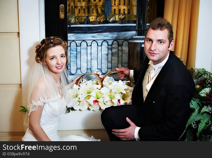 Happy bride and groom with big wedding rings