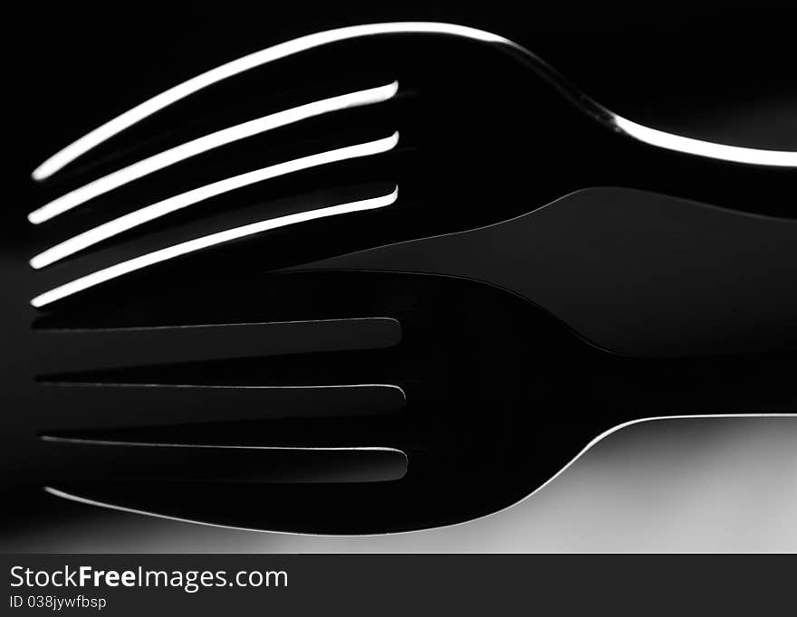 Low key image of a domestic fork with reflection