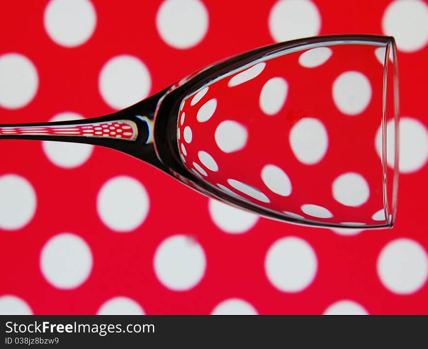 An abstract shot of a single wine glass against a trendy background. An abstract shot of a single wine glass against a trendy background