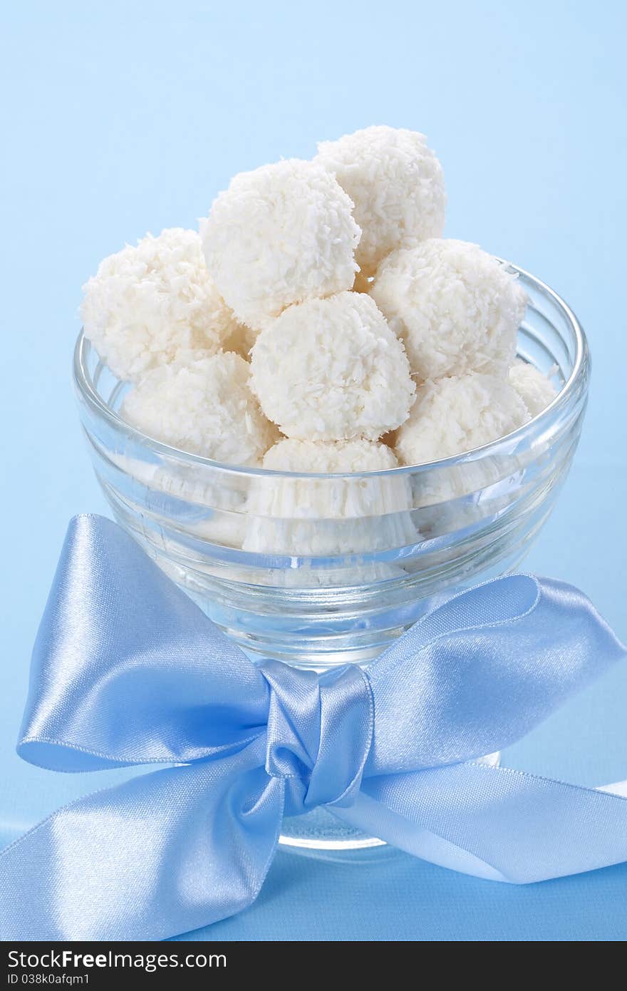 Homemade coconut candies in a bowl with a bow